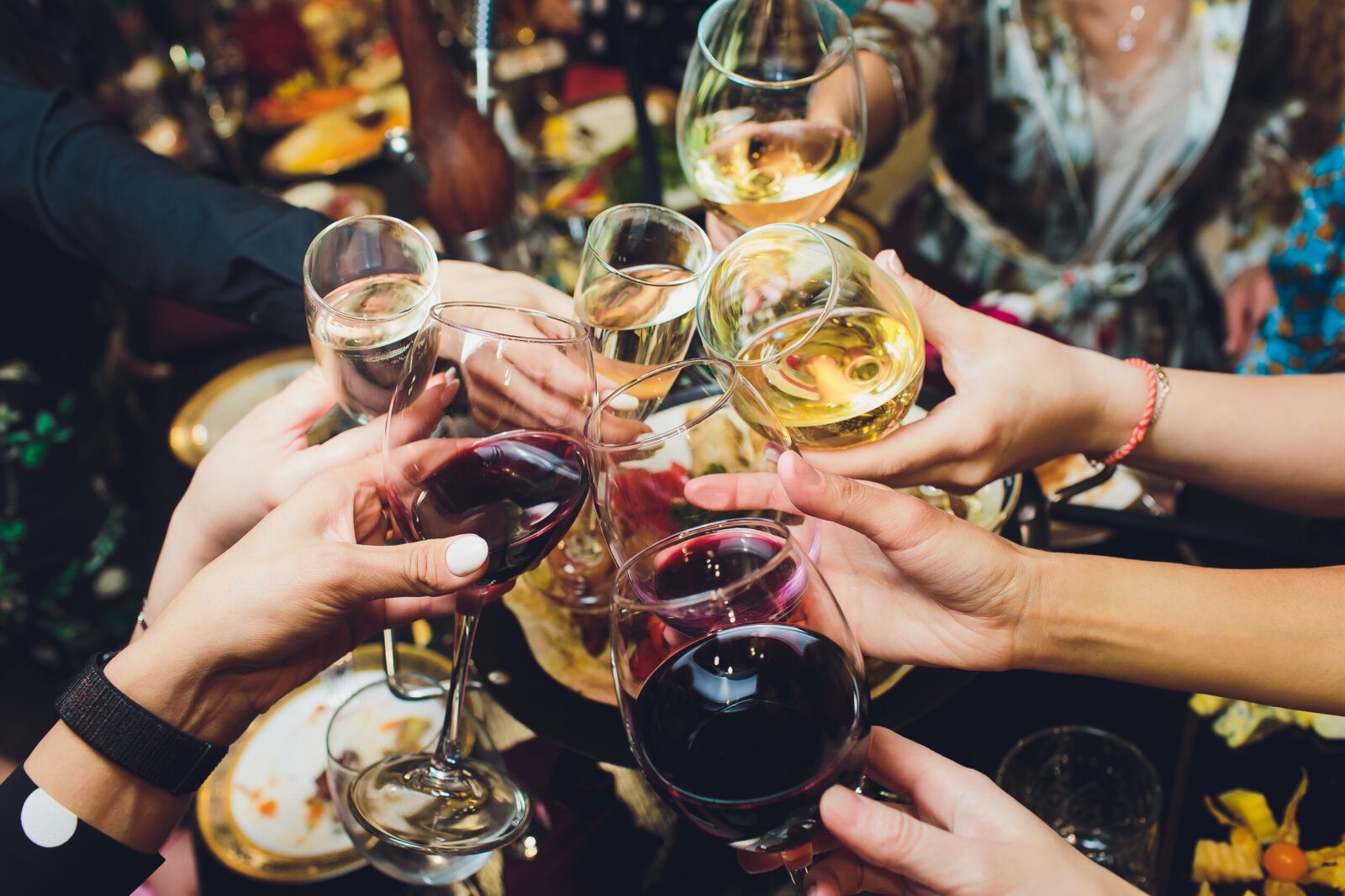 group of people celebrating with wine at restaurant