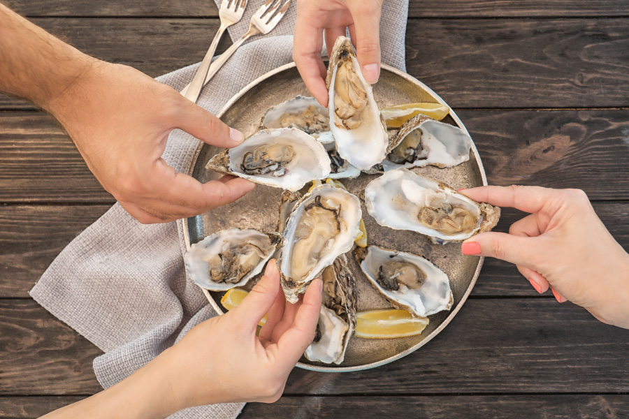 Group of friends enjoying a plate of fresh oysters